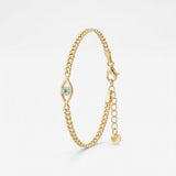 Gold evil eye bracelet on a Cuban curb chain, evil eye charm with a turquoise center and zircon halo, with extender