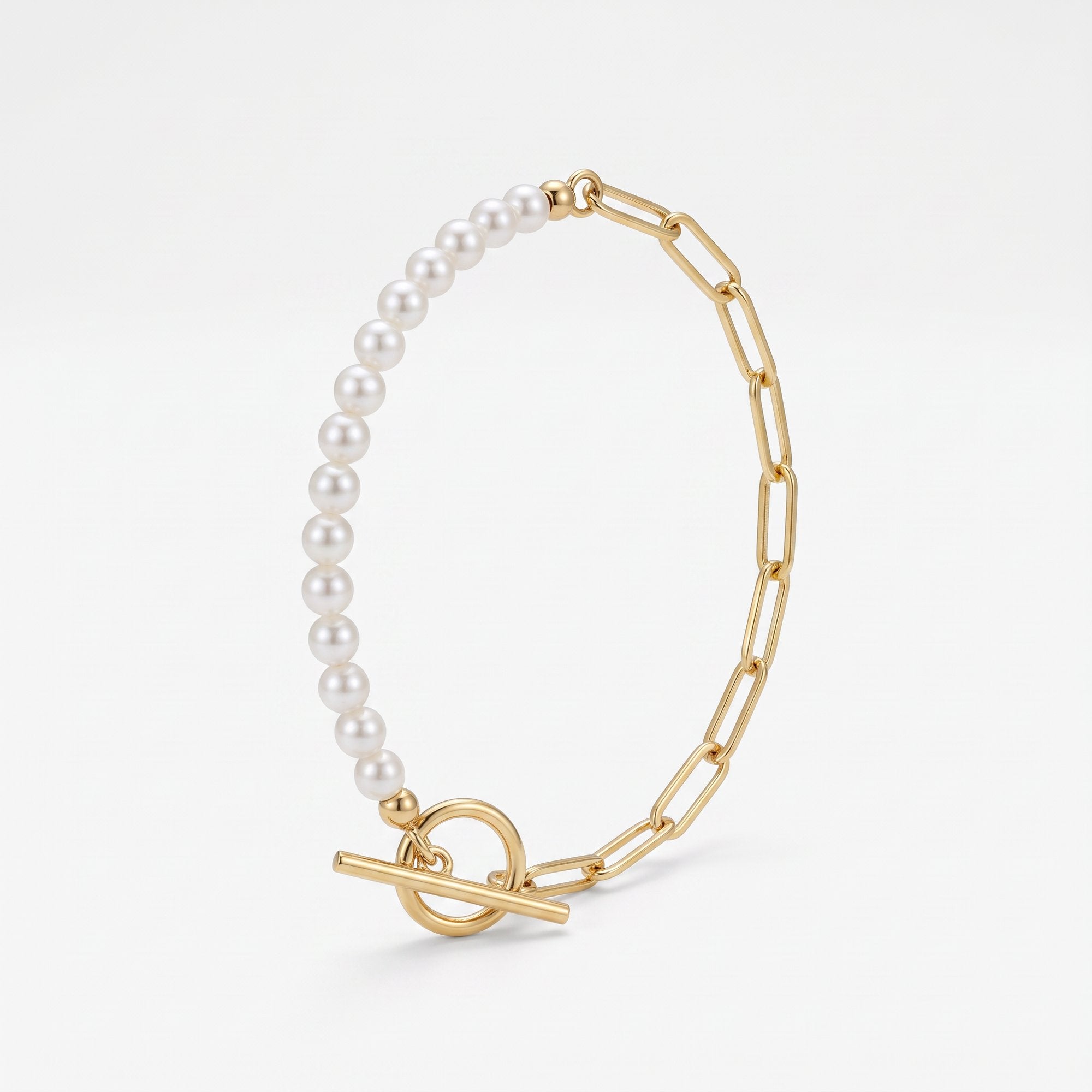 Gold paperclip bracelet with a half pearl strand and half paperclip chain, a toggle bracelet in 18K gold vermeil