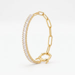 Gold paperclip bracelet with a baguette tennis section, half tennis half paperclip chain with a statement monster lock clasp