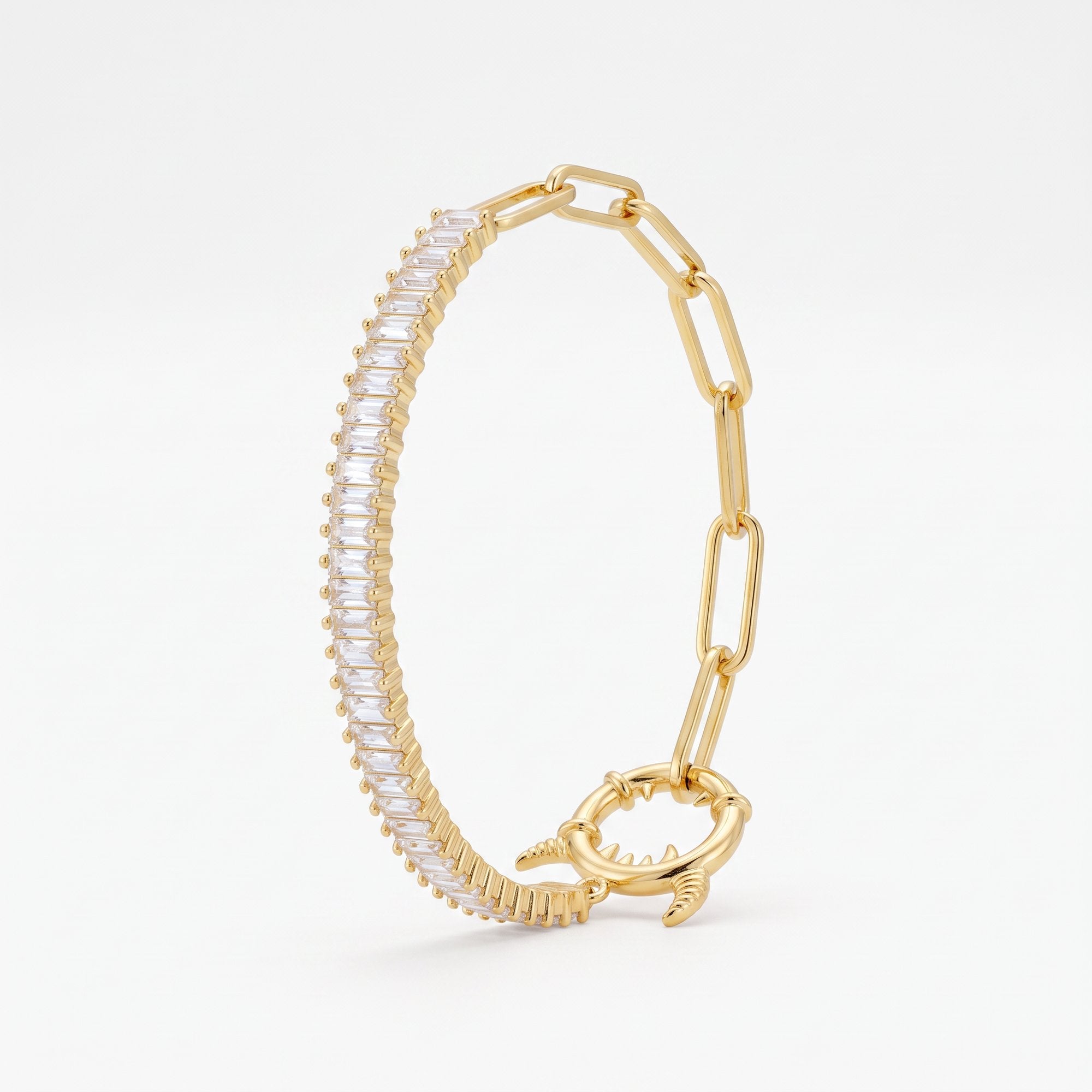 Gold paperclip bracelet with a baguette tennis section, half tennis half paperclip chain with a statement monster lock clasp