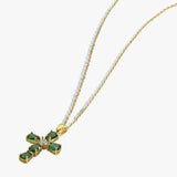 Gold chain with emerald cross pendant, white background, elegant jewelry design for fashion enthusiasts.