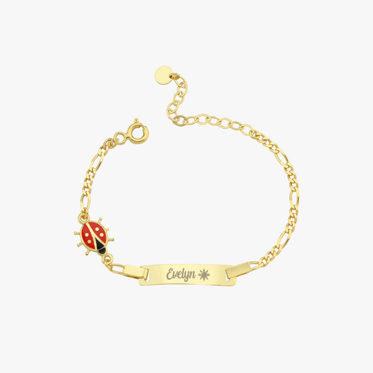 Gold baby bracelet with a ladybug charm and nameplate on a white background