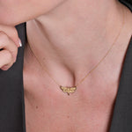 Elegant gold butterfly necklace on woman's neck, stylish jewelry fashion accessory close-up.