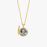 Gold locket necklace featuring vintage black-and-white portrait inside, elegant jewelry piece on white background.