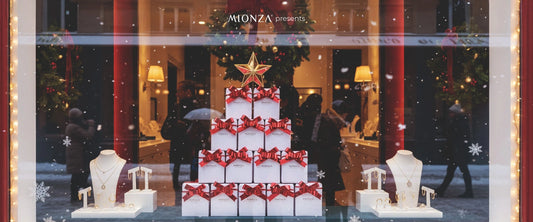 Christmas-themed jewelry display in a store window with presents and stars.