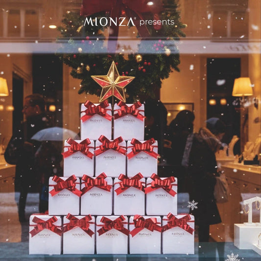 Christmas-themed jewelry display in a store window with presents and stars.