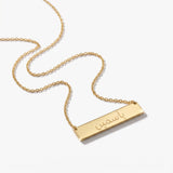 Gold Arabic name bar necklace engraved with a name in Arabic script