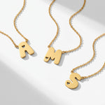 Gold bubble initial necklaces with heart cutout letters A, M and S