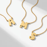 Gold bubble initial necklaces with heart cutout letters A, M and S