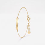 Engraved gold bar bracelet with a Roman numeral date, a personalized coordinates bracelet in 14K solid gold on a dainty chain