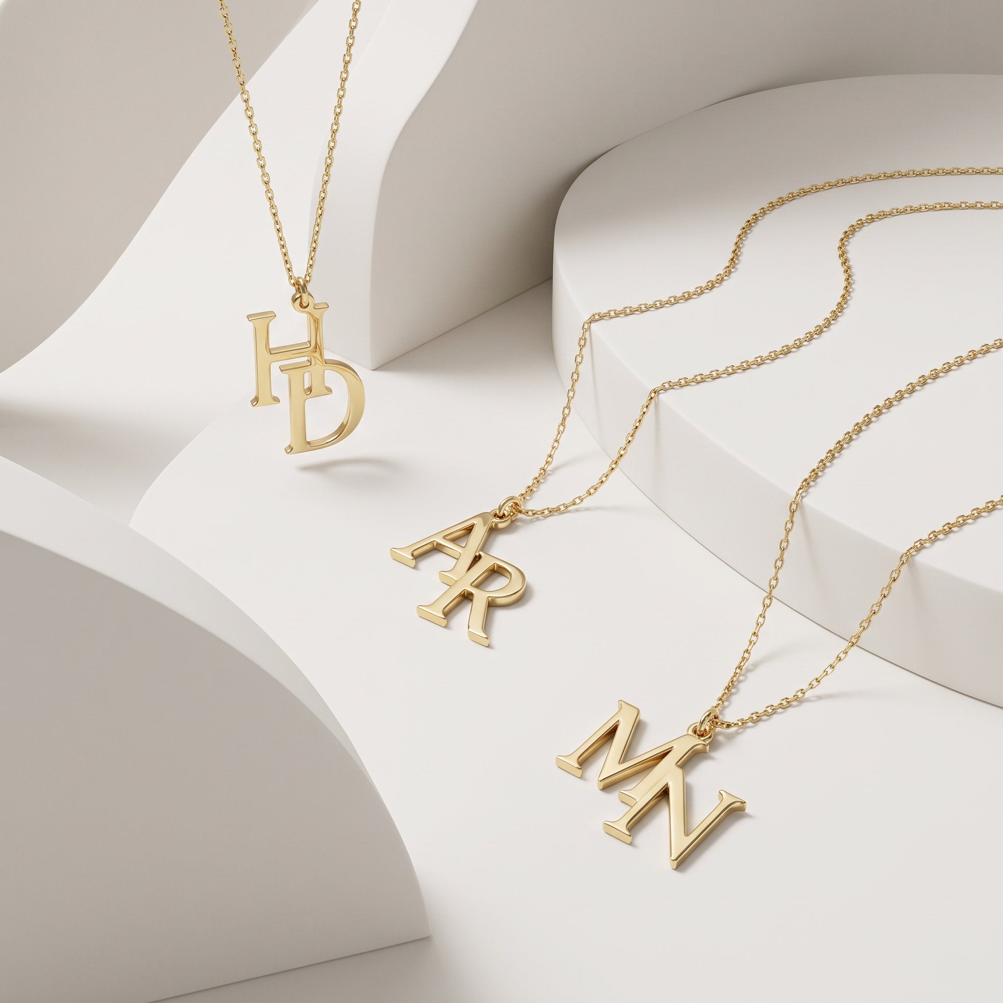 Gold couples initial necklaces with overlapping double letters