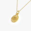 Detailed view of a 14K gold vermeil Eye of Horus necklace pendant showing intricate textures.