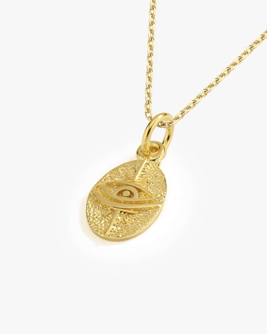 Detailed view of a 14K gold vermeil Eye of Horus necklace pendant showing intricate textures.