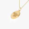 Detailed view of a 14K Gold Vermeil Bee Pendant Necklace with an embossed bee design on an oval pendant.