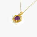 Close-up of a 14K gold vermeil necklace featuring an amethyst pendant, shown against a white background.