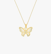 A sparkling 18K gold vermeil butterfly pendant on a fine gold chain, isolated on a white background.