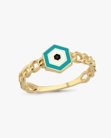 A detailed, isolated view of a gold chain ring featuring a hexagonal design with blue, white, and black colors forming an evil eye pattern.