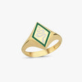 A gold snake signet ring with a green and white enamel snake design on a plain white background.