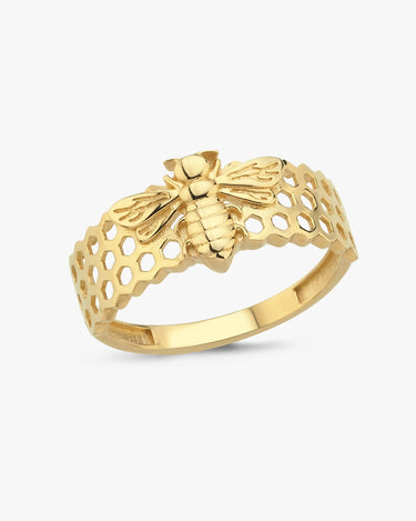 Isolated image of a gold bee ring with a detailed bee design and honeycomb pattern on a white background.