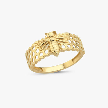 Isolated image of a gold bee ring with a detailed bee design and honeycomb pattern on a white background.