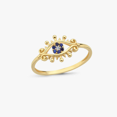 A gold evil eye ring with blue stones on a white background.