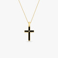 Product shot of a 14K gold vermeil black cross necklace against a white background.