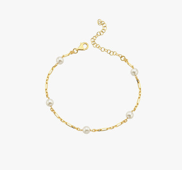 A minimalistic 18K gold vermeil bracelet with evenly spaced white pearls, elegantly laid out against a white background, displaying the simplicity and charm of the design.