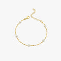 A minimalistic 18K gold vermeil bracelet with evenly spaced white pearls, elegantly laid out against a white background, displaying the simplicity and charm of the design.