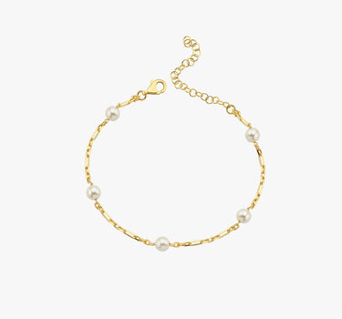 A minimalistic 18K gold vermeil bracelet with evenly spaced white pearls, elegantly laid out against a white background, displaying the simplicity and charm of the design.