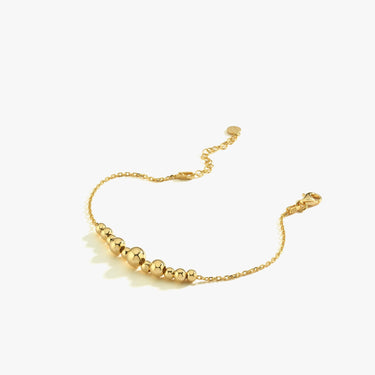 A standalone 18K Gold Vermeil beaded bracelet laid flat on a white background, showcasing its adjustable clasp and alternating bead sizes.