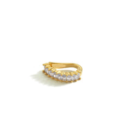 A gold ear cuff with baguette-cut clear stones, shown against a white background. The cuff is designed to fit snugly around the upper ear with a sleek, curved band.