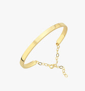 An 18K gold vermeil cuff bracelet with a small chain extender displayed on a white background.