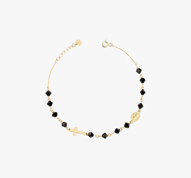 A 14K gold bracelet with black onyx beads, a cross charm, and a small medallion, displayed flat on a white background.