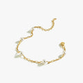 A single 18K gold vermeil bracelet with a delicate chain and small white pearls evenly spaced along the chain, laid flat on a white background to showcase its details.