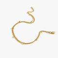 A laid-out 18K gold vermeil double chain anklet with small gold beads, displayed on a white background, showing the full length and adjustable clasp of the jewelry piece.