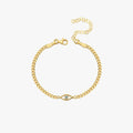 18K Gold Vermeil Evil Eye Curb Chain Bracelet laid flat on a white surface, highlighting the gold curb chain and the eye-shaped charm with a clear gemstone in the center.