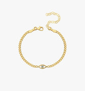 18K Gold Vermeil Evil Eye Curb Chain Bracelet laid flat on a white surface, highlighting the gold curb chain and the eye-shaped charm with a clear gemstone in the center.