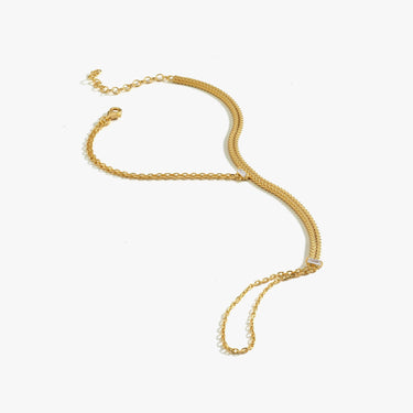 A single gold vermeil herringbone hand chain bracelet laid out on a white background, showcasing its sleek, minimalist design.