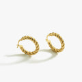 A pair of medium-sized twisted hoop earrings in 18K gold vermeil on a white background.