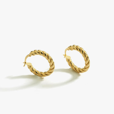 A pair of medium-sized twisted hoop earrings in 18K gold vermeil on a white background.