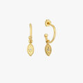 Pair of 18K gold vermeil North Star and evil eye hoop earrings on a white background. The earrings have small oval pendants with star details and are crafted from gold vermeil.