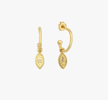 Pair of 18K gold vermeil North Star and evil eye hoop earrings on a white background. The earrings have small oval pendants with star details and are crafted from gold vermeil.