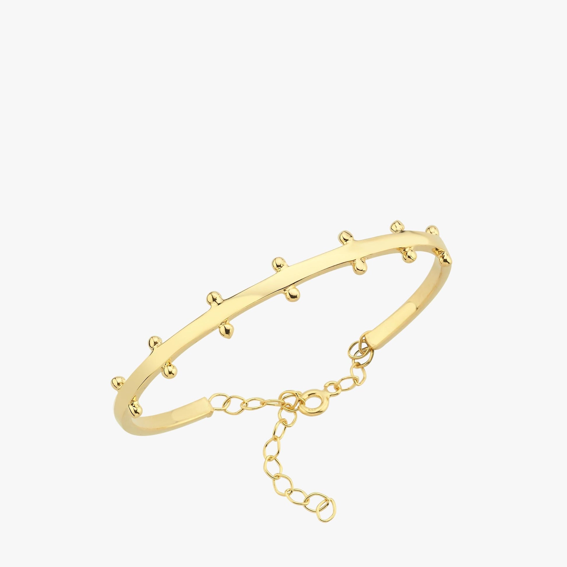 A close-up product image of the 18K gold vermeil station cuff bracelet, featuring small gold rounded stations along its curved band and a delicate chain clasp for adjustable sizing.