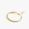 A single thin gold vermeil bangle bracelet with a delicate chain clasp, displayed on a white background.