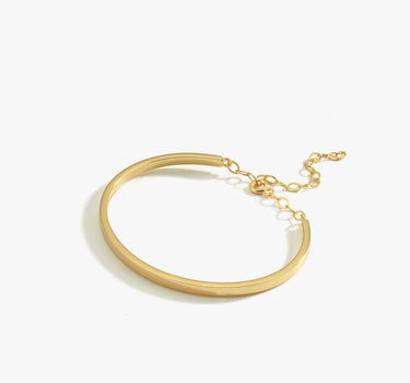 A single thin gold vermeil bangle bracelet with a delicate chain clasp, displayed on a white background.