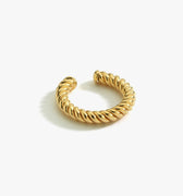 Isolated product shot of an 18K gold vermeil twist ear cuff displayed against a white background. The ear cuff has a thick, twisted rope design and an open shape easy wear.