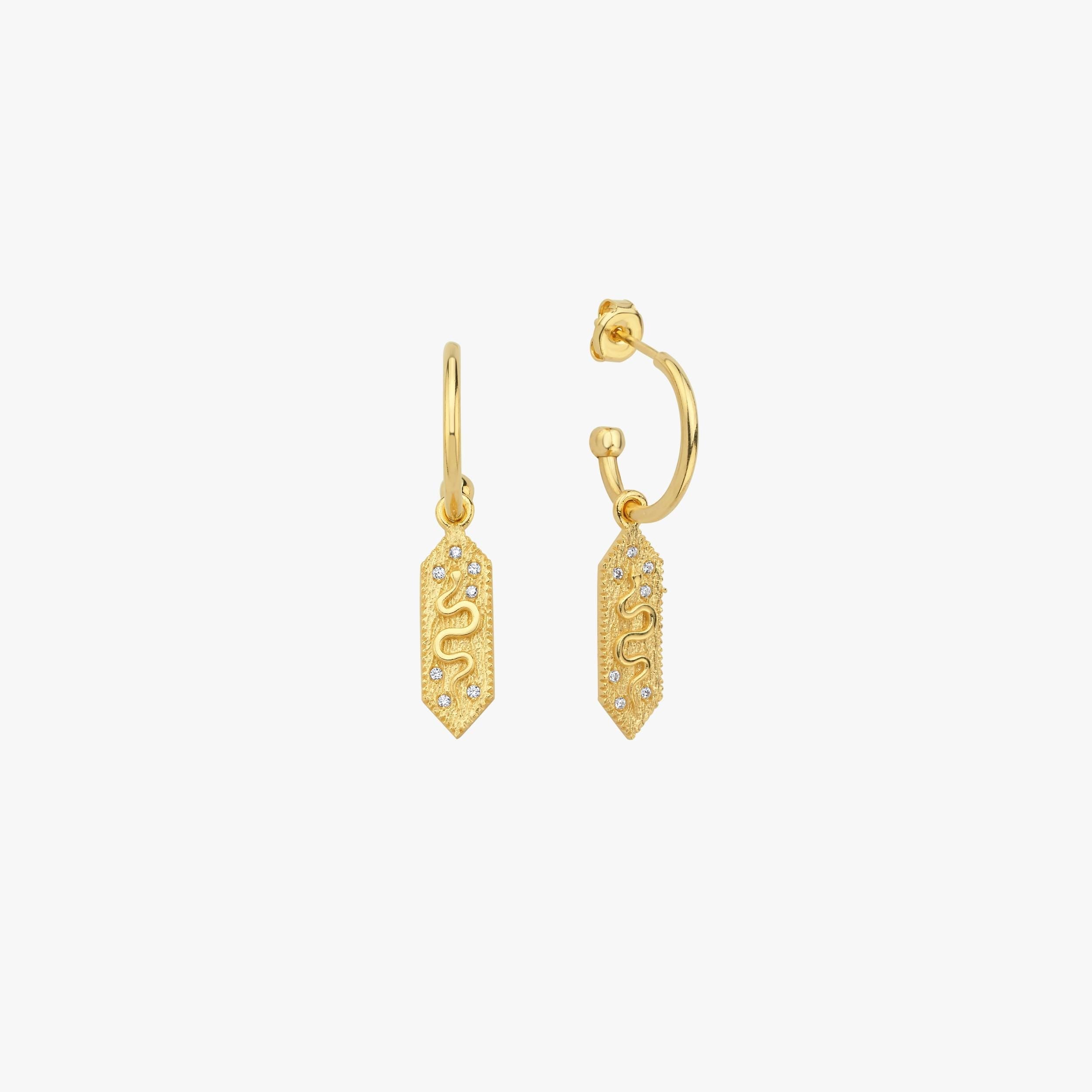 A pair of 18k gold vermeil dangle earrings with a rectangular charm featuring a snake design, set against a plain white background.