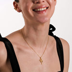 A woman in a black dress wearing the 18K Gold Vermeil Snake Necklace, emphasizing its delicate and stylish look.