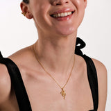 A woman in a black dress wearing the 18K Gold Vermeil Snake Necklace, emphasizing its delicate and stylish look.