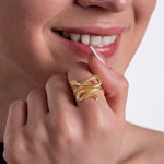 A bold 18K gold vermeil snake ring with a fluid, sculptural design wrapping around the finger.